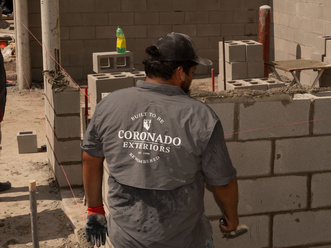 Coronado Exteriors crew building a CMU privacy wall in Houston