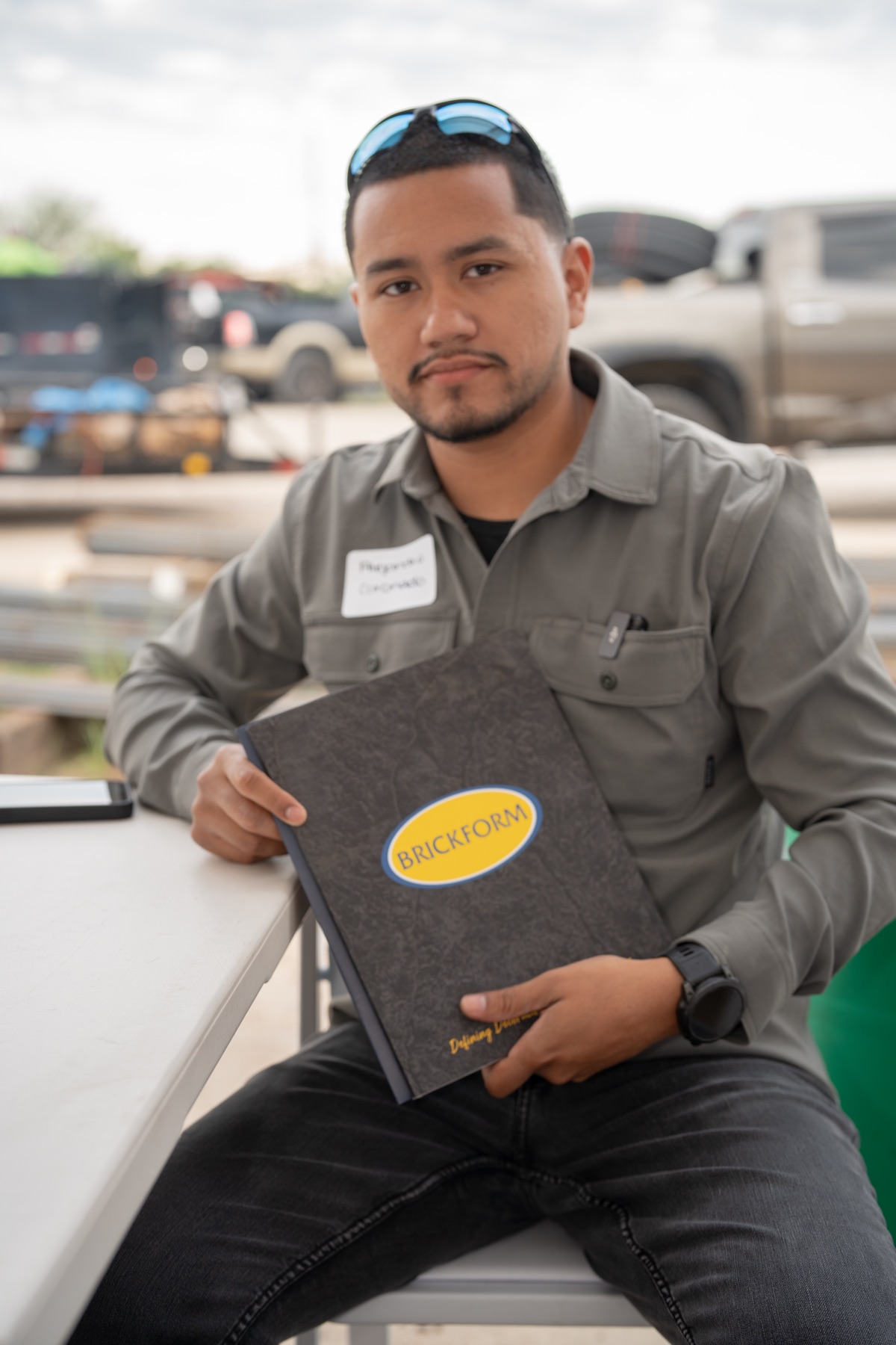 Alejandro Coronado holding a Brickform decorative concrete catalog