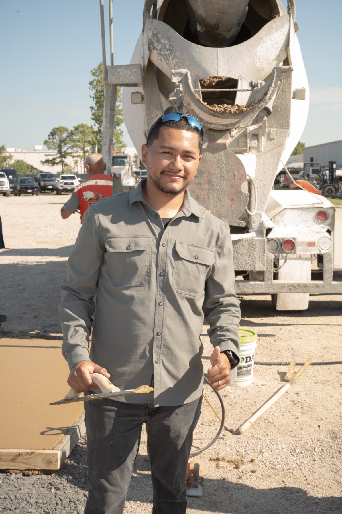 Alejandro Coronado, owner of Coronado Exteriors, on a concrete pour in front of a ready-mix truck