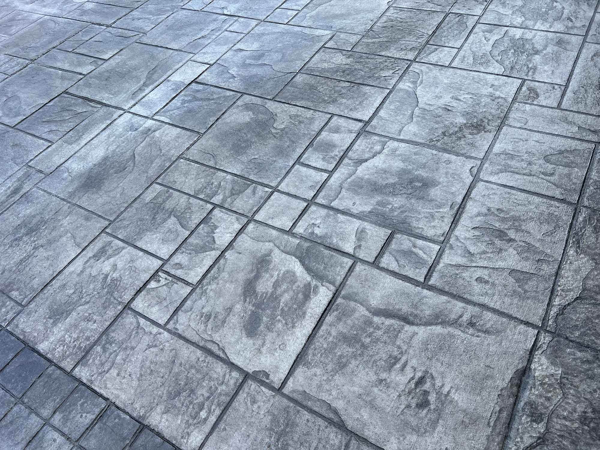Flagstone concrete overlay surface with warm stone pattern