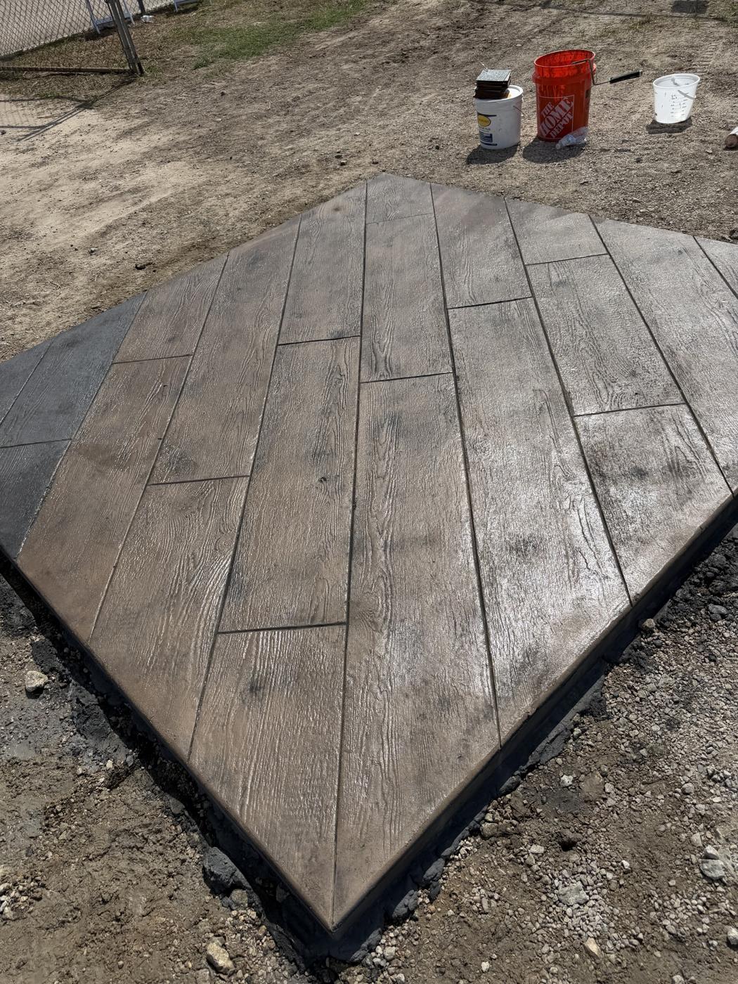 Brown wood plank stamped concrete slab with realistic wood grain by Coronado Exteriors