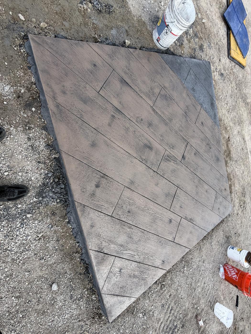 Overhead view of wood plank stamped concrete with a contrasting gray border by Coronado Exteriors
