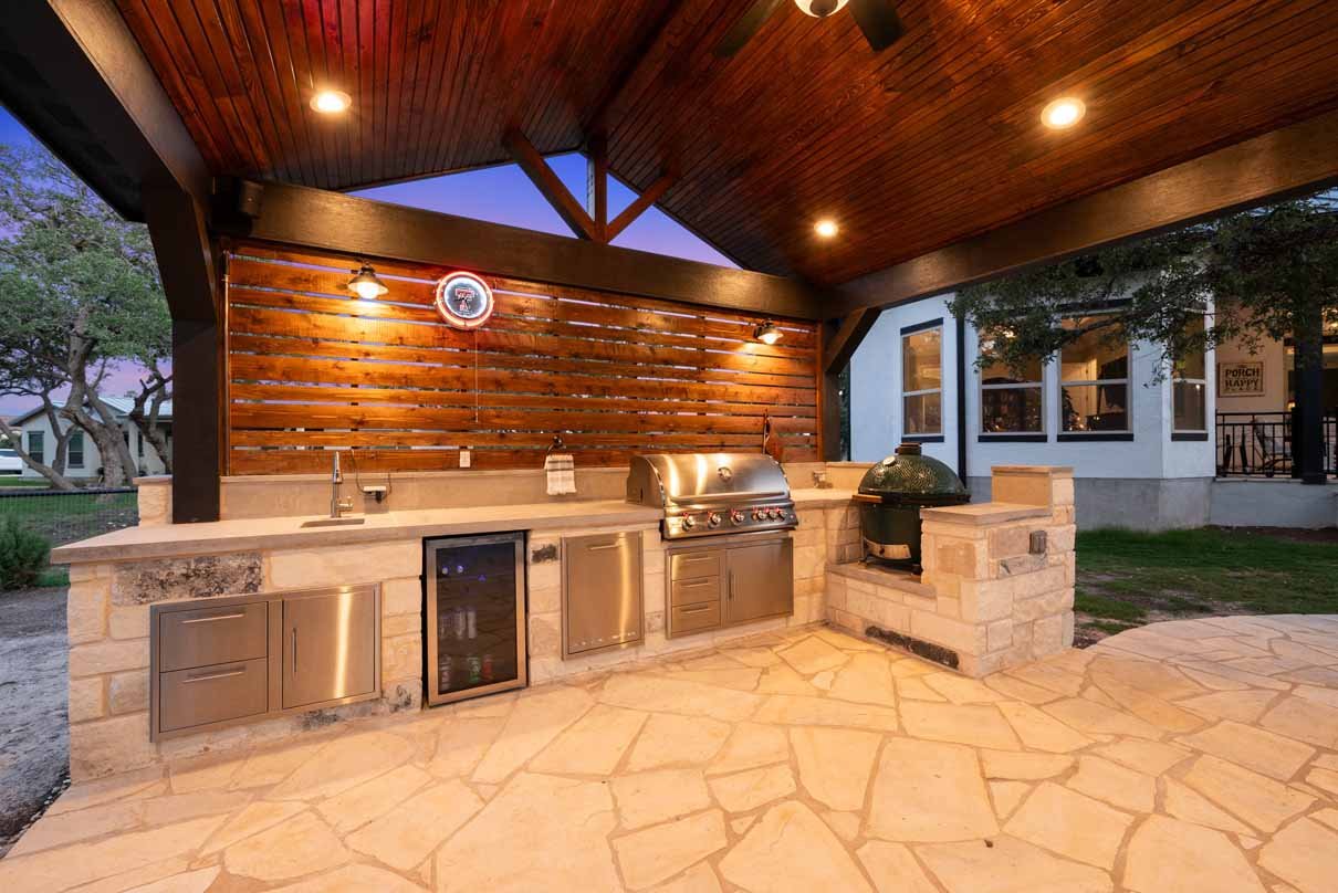 Covered patio structure protecting an outdoor kitchen by Coronado Exteriors
